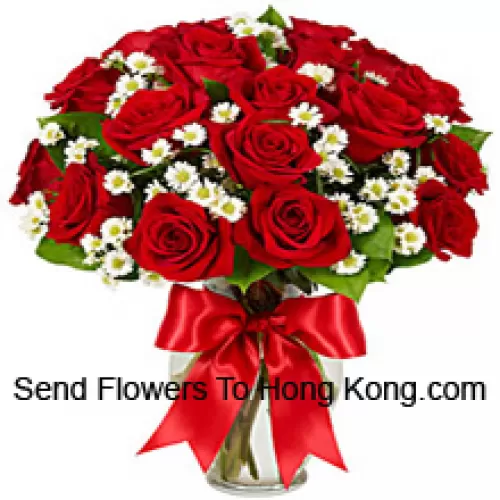 24 Red Roses With Some Ferns In A Glass Vase
