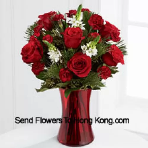 This romantic arrangement bristles with the passion and wonder of the Chinese New Year season. Rich red roses and burgundy mini carnations accented with the snowy white blooms of Stars of Bethlehem, pine branches, and lush greens will easily sweep them off their feet. Arranged in a ruby red clear glass vase, this bouquet conveys your most heartfelt holiday wishes. (Please Note That We Reserve The Right To Substitute Any Product With A Suitable Product Of Equal Value In Case Of Non-Availability Of A Certain Product)