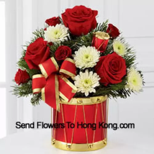 A blossoming display of seasonal merriment and festive greetings. Rich red roses and spray roses sweetly mingle with white chrysanthemums arranged amongst lush holiday greens, all perfectly accented with drum pics and a gold-edged red ribbon. Arriving in a designer red and gold drum inspired vase, this bouquet will express your most heartfelt wishes for a wonderful holiday season. (Please Note That We Reserve The Right To Substitute Any Product With A Suitable Product Of Equal Value In Case Of Non-Availability Of A Certain Product)
