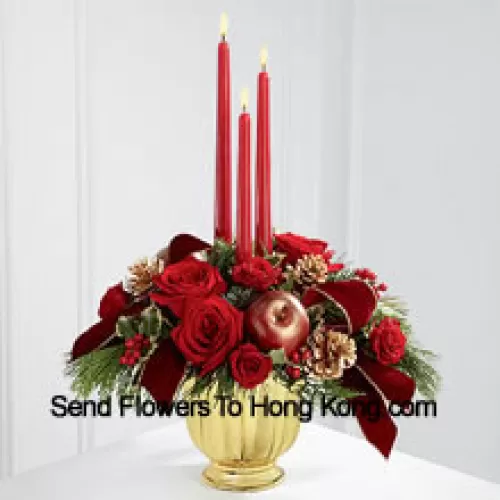 The grandeur and rich beauty of the Christmas season are highlighted with each crimson bloom. Bright red roses and spray roses are arranged in a designer gold container amongst variegated holly and assorted holiday greens. Accented with artificial apples, gold pinecones and gold-edged burgundy ribbon, this gorgeous centerpiece displays three red taper candles to create the perfect atmosphere for their holiday celebration.  (Please Note That We Reserve The Right To Substitute Any Product With A Suitable Product Of Equal Value In Case Of Non-Availability Of A Certain Product)